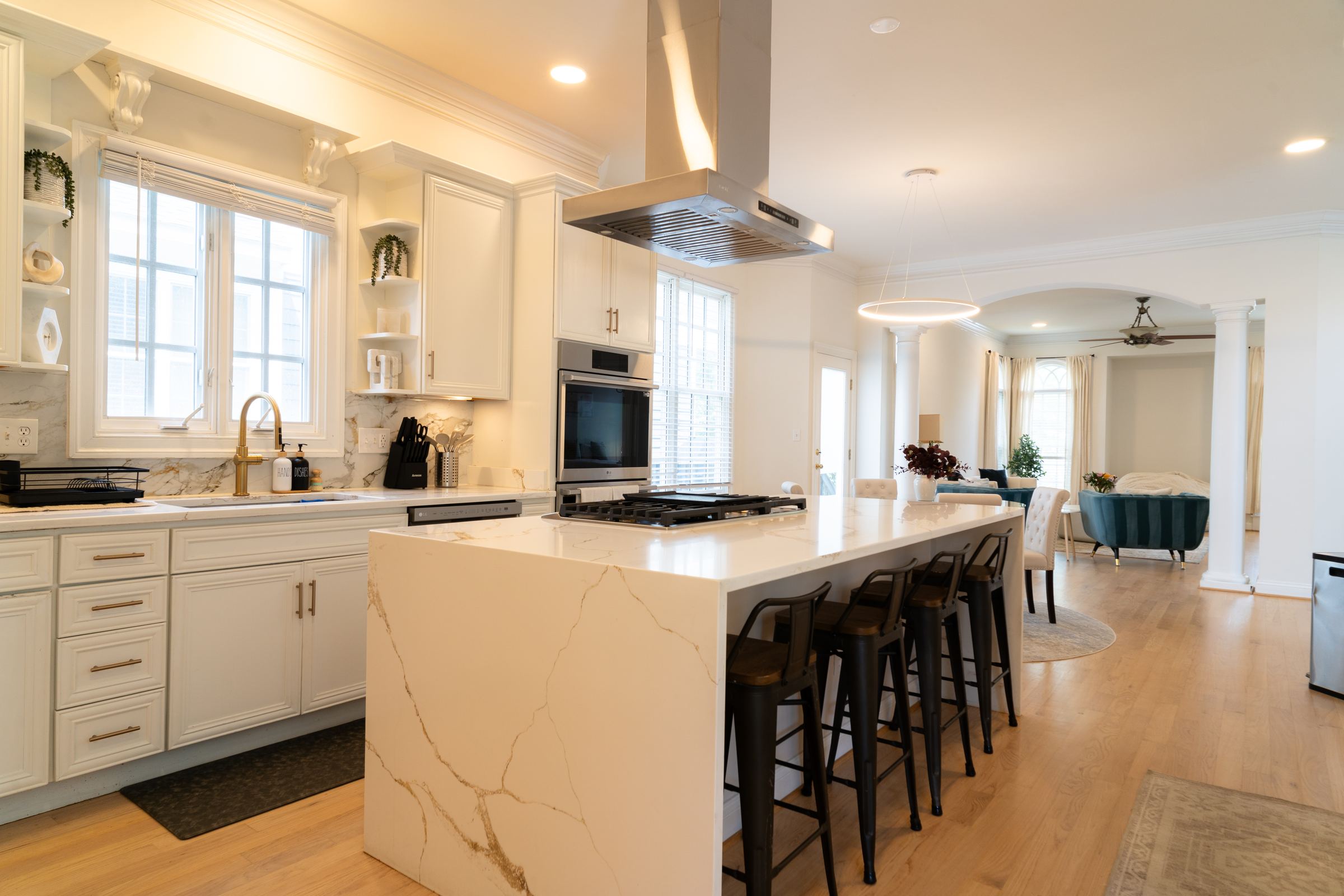 Kitchen with quartz waterfall island and seating for four