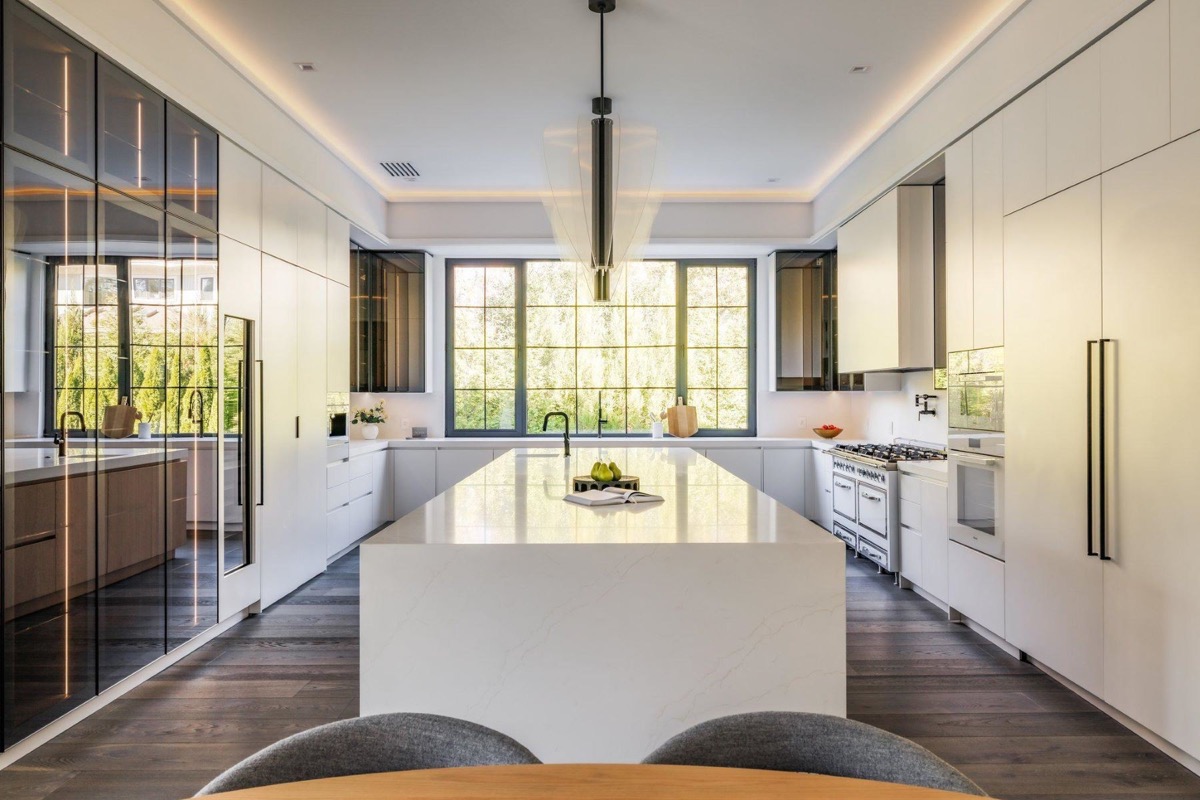 Kitchen with quartz waterfall island and brass fixtures